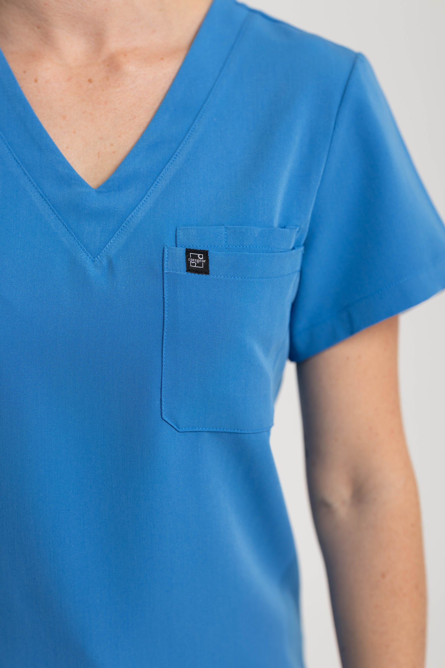 Women's V Neck Scrub top with Chest Pockets in Azure Blue